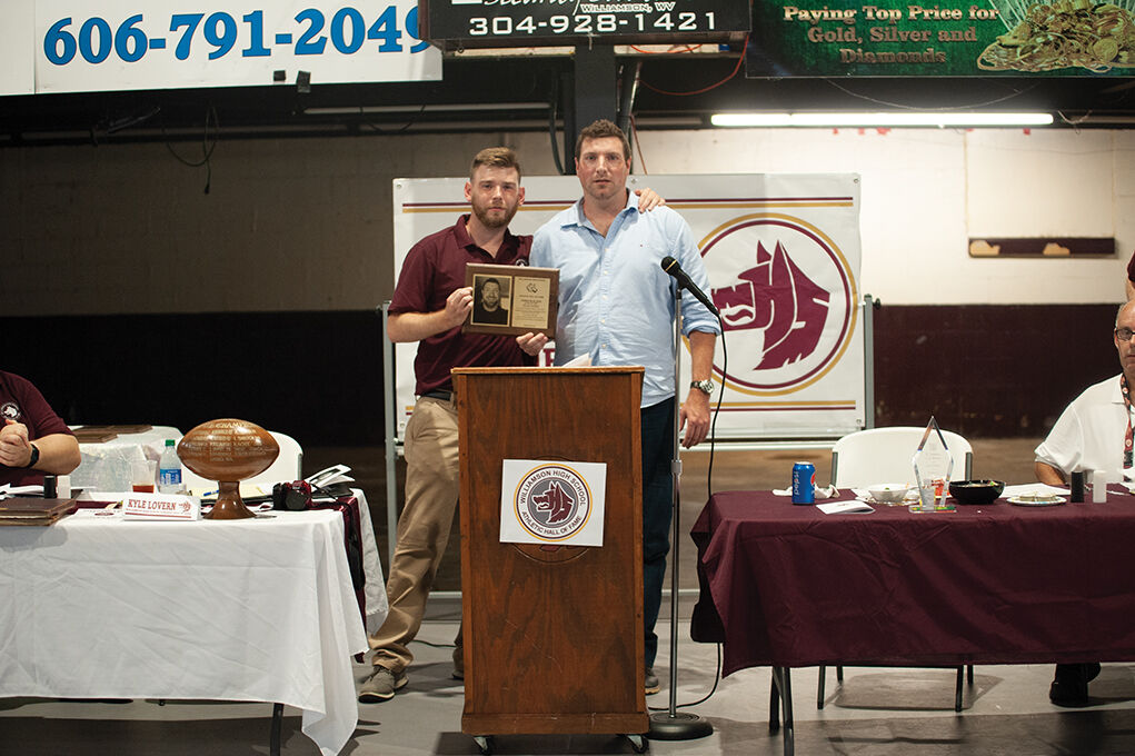 9-23 WHS Athletic Hall of Fame board member Jarrid McCormick and Blalock taking picture with Blalock's plaque.jpg